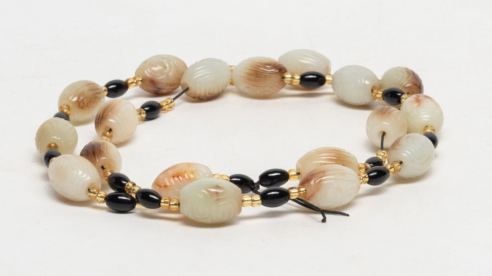 Estate Chinese Jade / Hard Stone Necklace: Chinese jade/ stone carved bead necklace. Approx. 29 inch L.