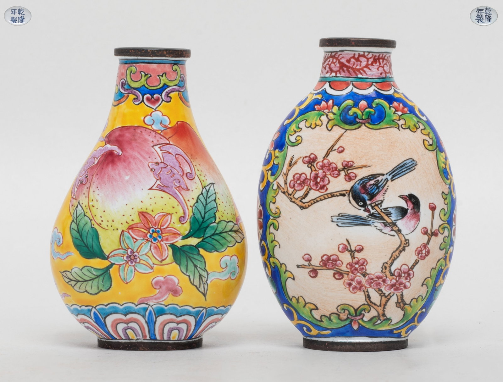Two Chinese Enameled on Brass Snuff Bottles: One snuff bottle enameled with peaches and bats, the other enameled birds and flower tree, each marked four characters to bottom. Approx. 2.55*1.65*1 inch (larger).