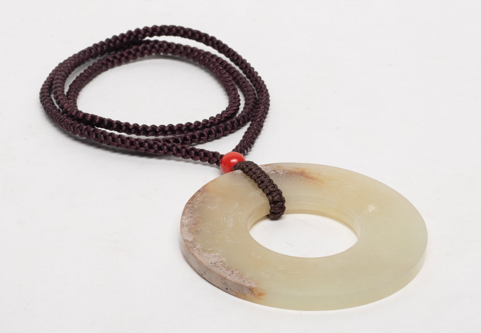 Chinese Russet Jade Rounded Pendant: Chinese russet jade pendant of rounded shape, either side incised mythical beasts. Approx. 2.8 inch D.