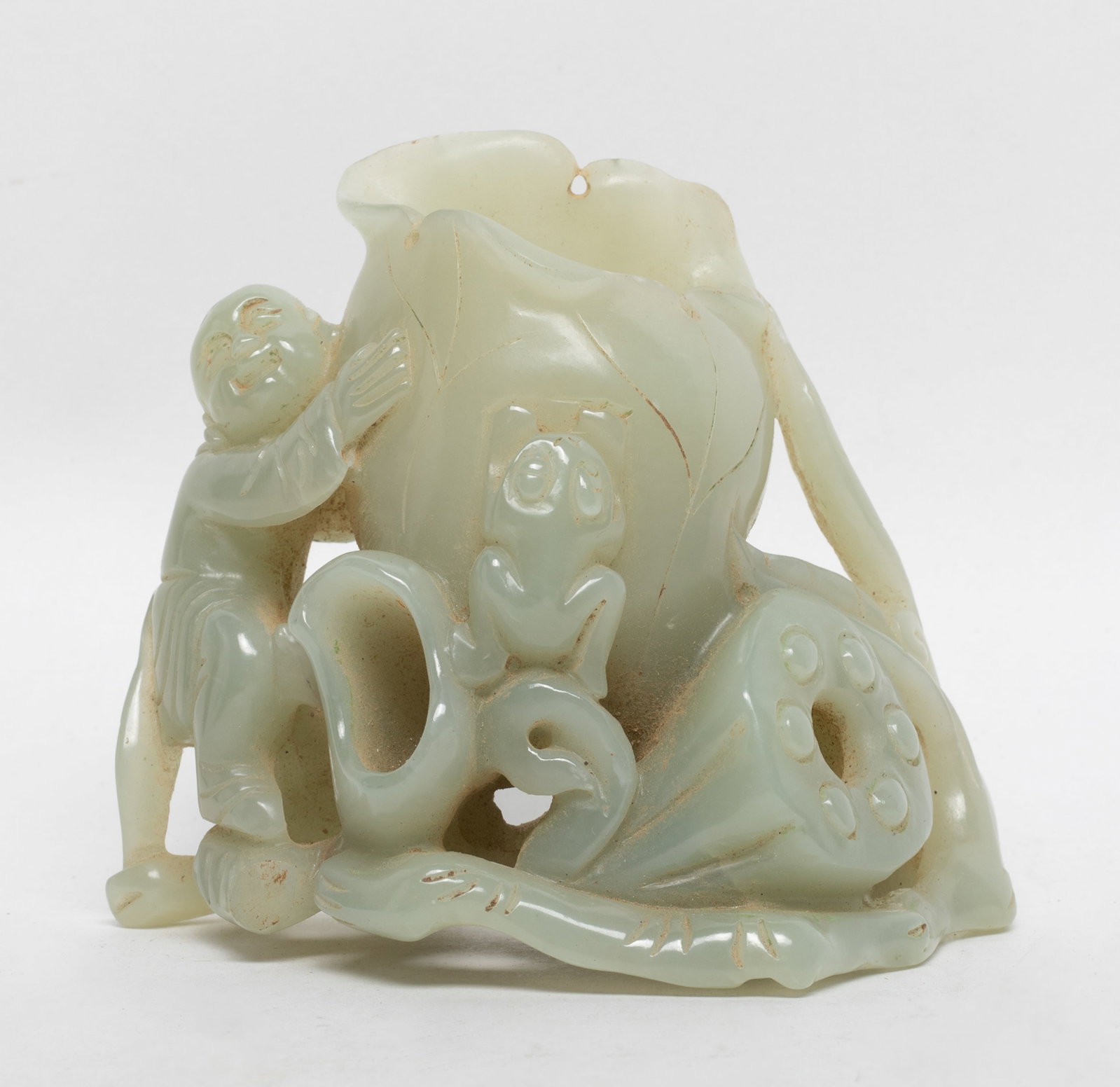 Chinese Jade Carved Sculpture of Vase: Chinese pale celadon jade vase sculpture carved with lotus leaf, lotus seedpod, boy, frog and lingzhi stem. Approx. 3.8*3.3*2.1 inch.