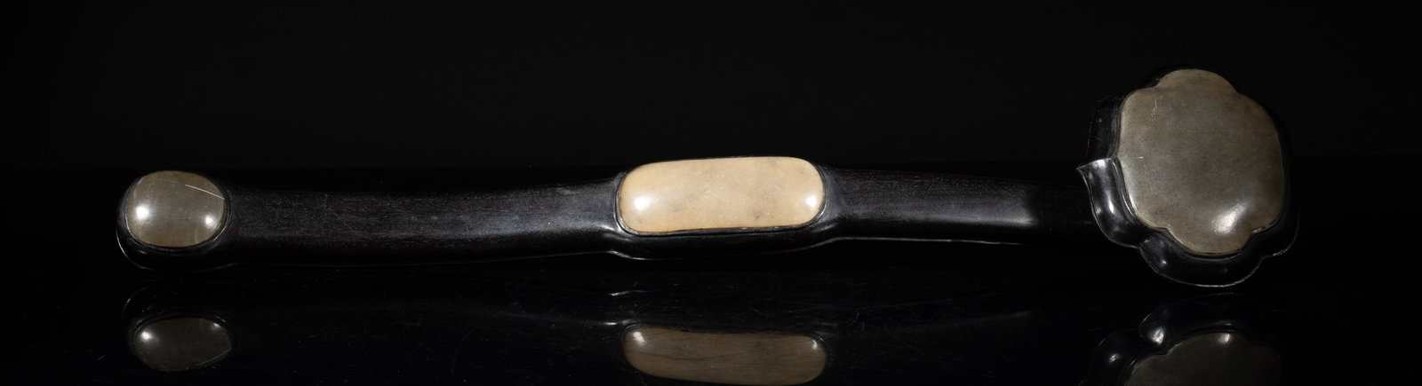Long Chinese Wood Sculpture of Ruyi: The scepter head, midpoint, and tail mounted with convex stone plaques, the stone a mottled grey hue. Approx. 18.7*3.9*2.5 inch.