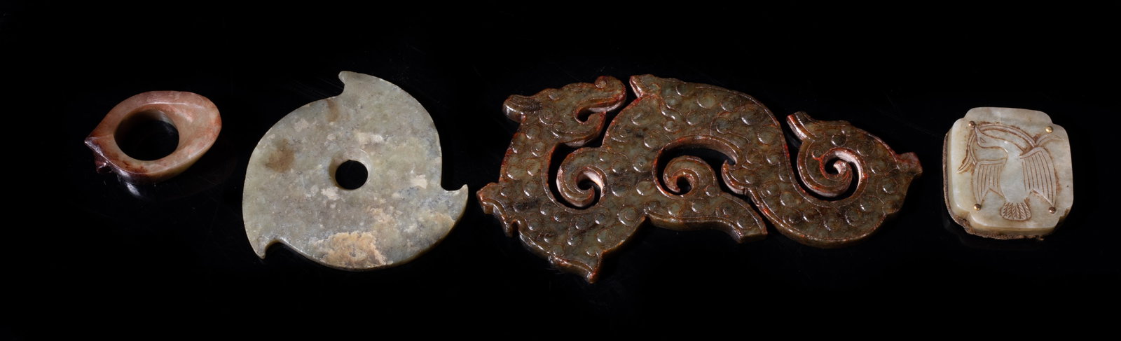 Estate Set Four Chinese Jade Carvings: Set of four Chinese jade carvings, including an archaic form disc, a plaque carved with a bird, a special shaped toggle, and a large S-shaped dragon form carving. Approx. 6.3*3.2 inch (largest).