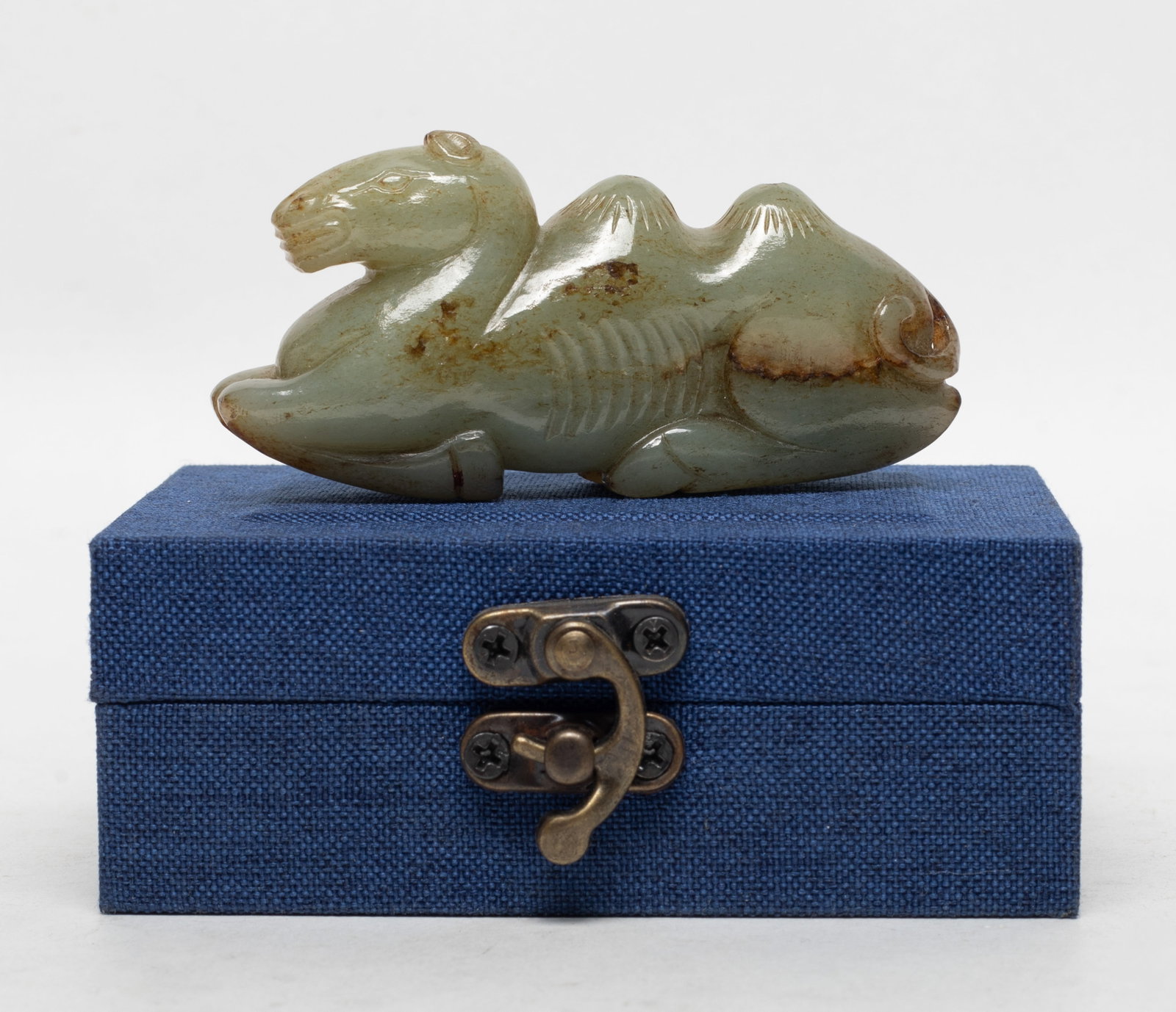 Chinese Early Type Jade Brush Stand: Chinese russet jade carved brush stand of recumbent camel form, with box. Approx. 3.2*1.55*0.87 inch (jade size).