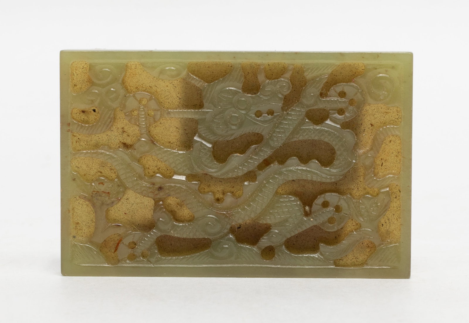 Chinese Jade Carved Dragon Pendant: Chinese green jade plaque carved with sinuous dragon. Approx. 2.3*1.5 inch.