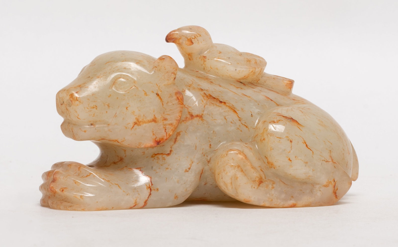 Chinese Jade Carved Table Sculpture: Chinese russet jade sculpture carved as a bird on a recumbent beast. Approx. 3.4*1.8*1.5 inch.