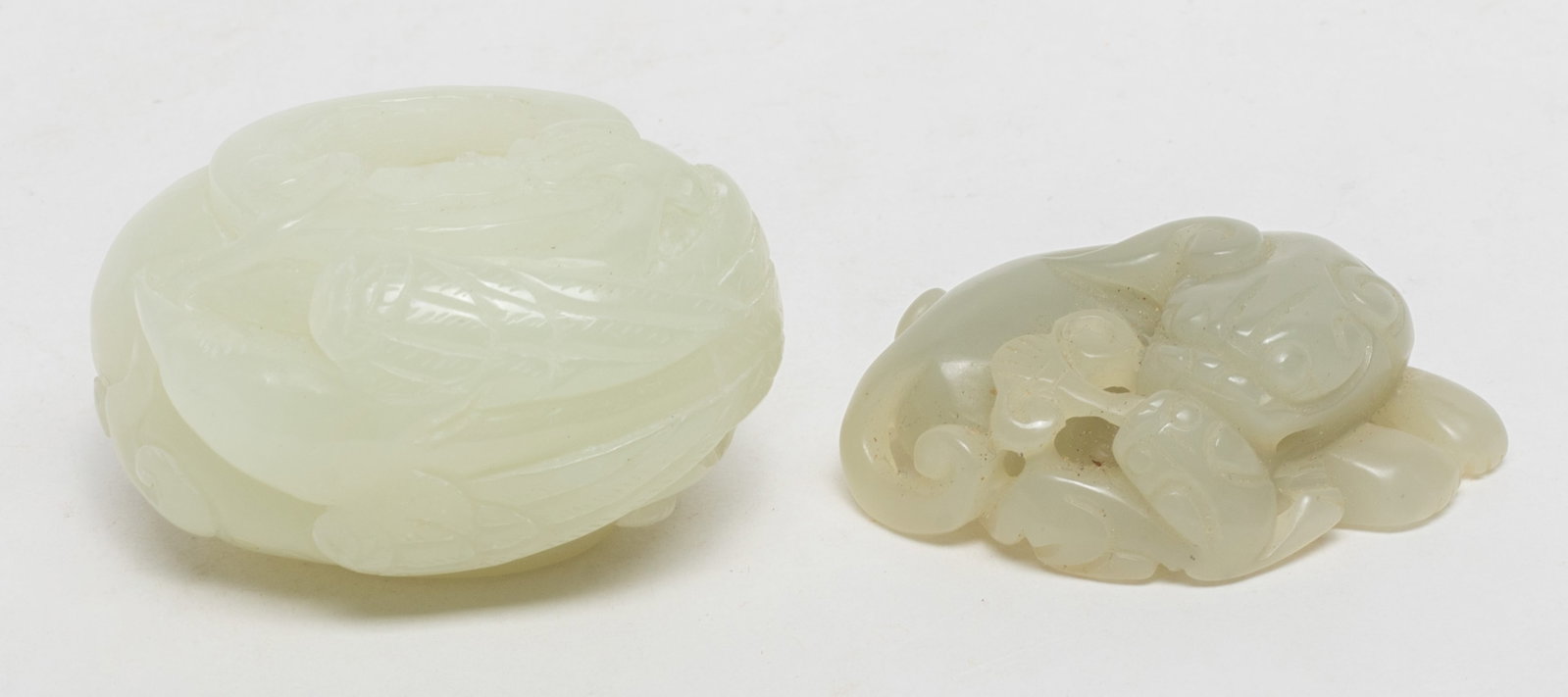 Estate Two Chinese Jade Carvings: One carved as a recumbent beast and its cub grasping lingzhi, the other jade washer carved with a bird grasping lingzhi. Approx. 2*1.6*1.2 inch (larger).