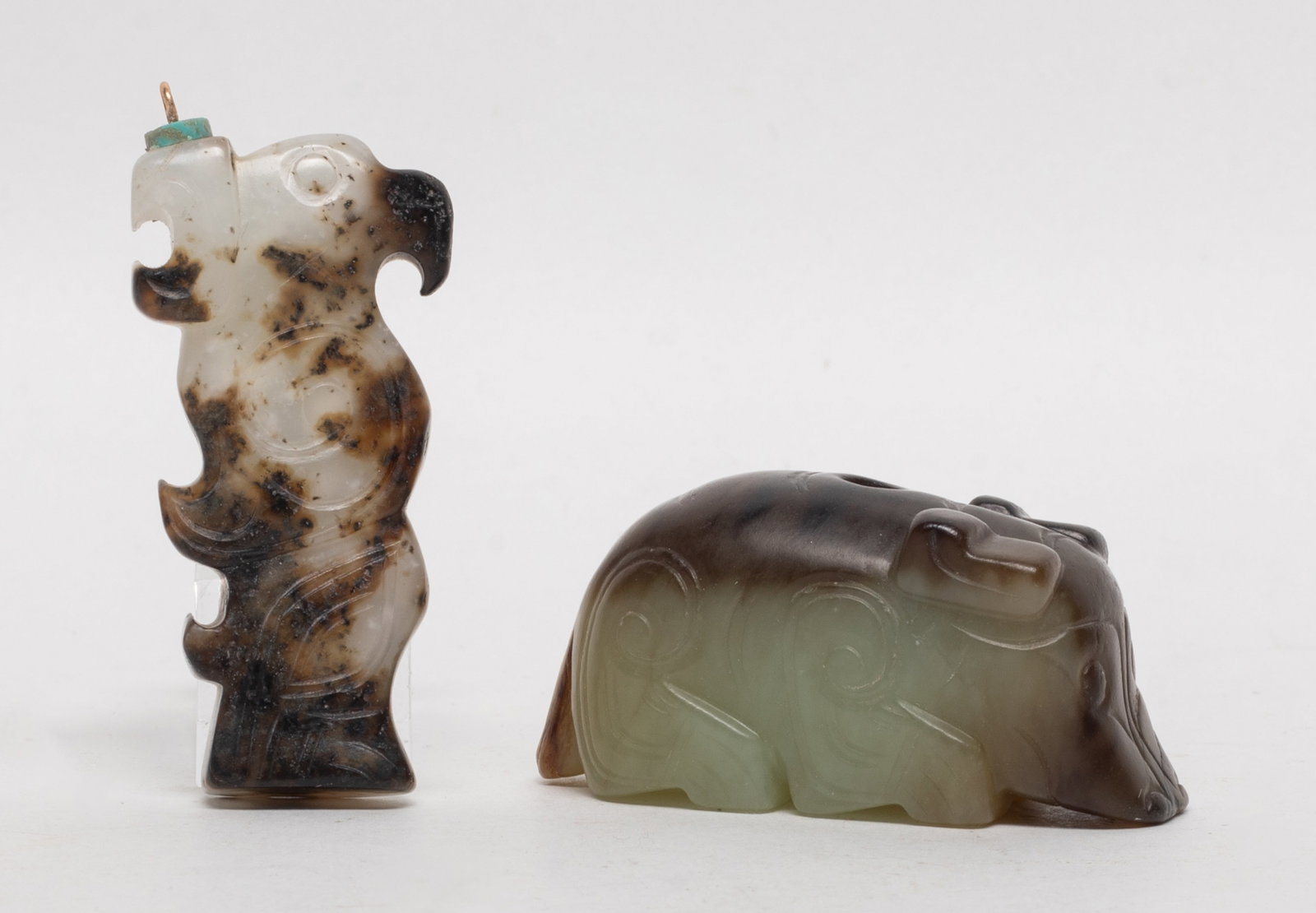 Estate Two Chinese Export Jade Pendants: Two Chinese archaistic style russet jade pendants, one carved of beast form and the other of bird form. Approx. 2.2*1.07*0.95 inch (larger).