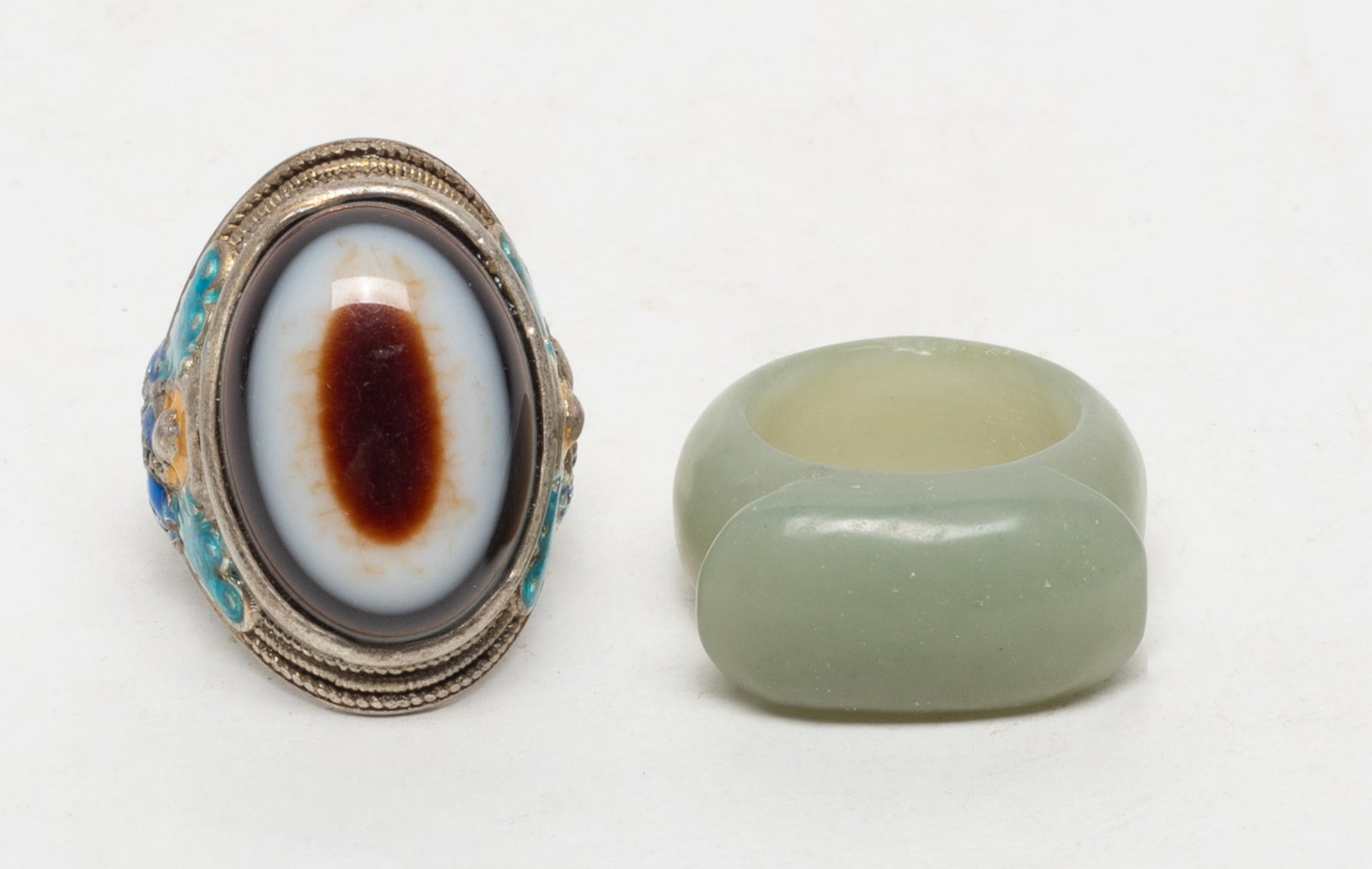 Estate Chinese Jade, Dzi Bead Rings: Including a jade thumb ring and a dzi bead inlaid ring, marked four characters. US size: 9.5 (larger).