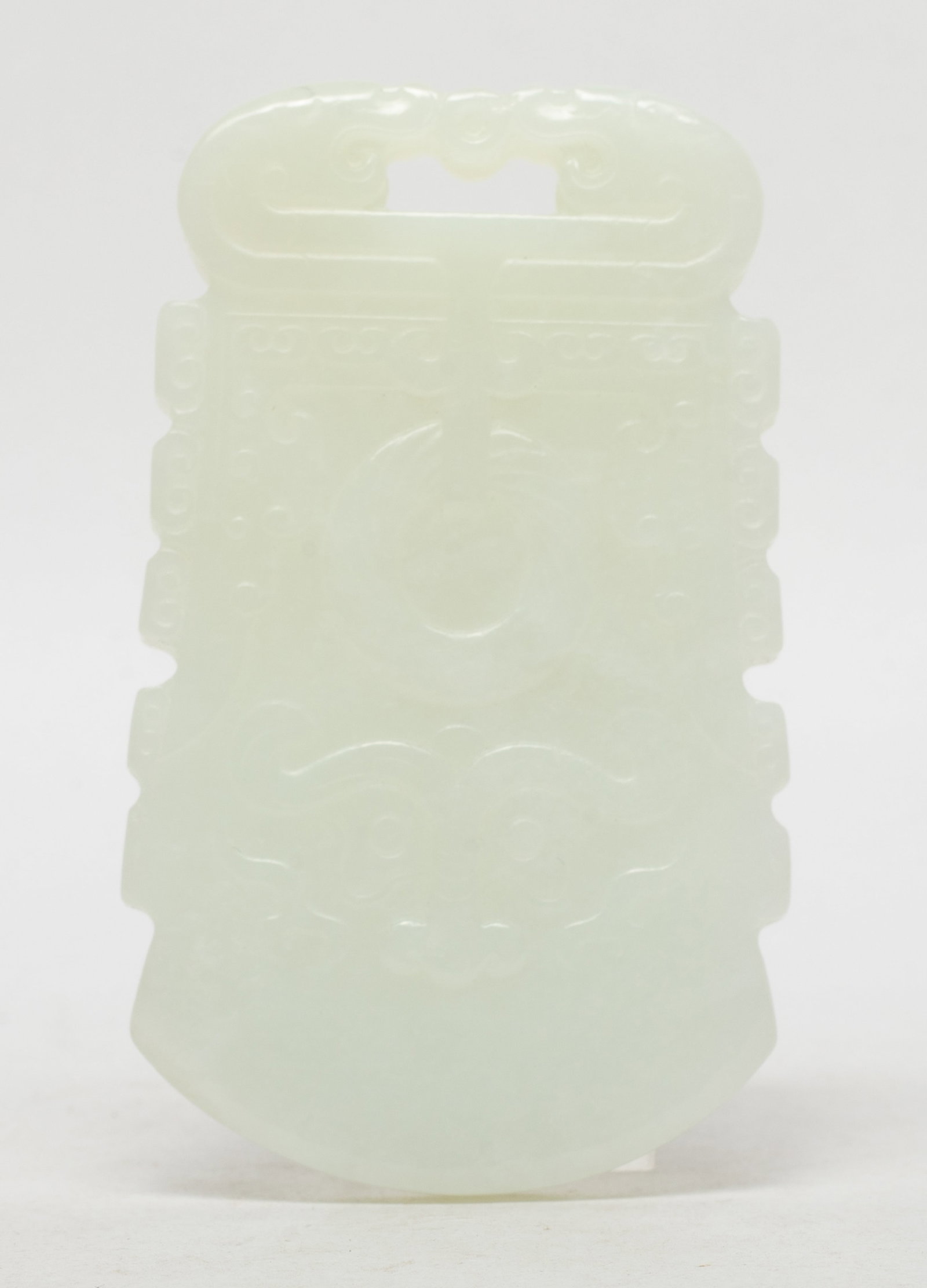 Estate Chinese White Jade / Stone Plaque: Either side carved with a huan suspended on a pair of confronting beasts, below with a buffalo mask. Approx. 3.2*1.9 inch.