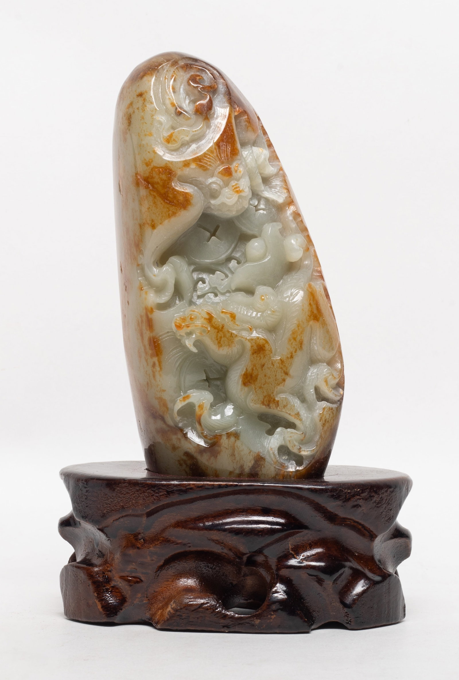 Vintage Chinese Russet Pebble Jade Sculpture: Chinese large russet pebble jade sculpture, carved in high relief with beasts, with wood stand. Approx. 6.4*2.8*1.75 inch (jade size).