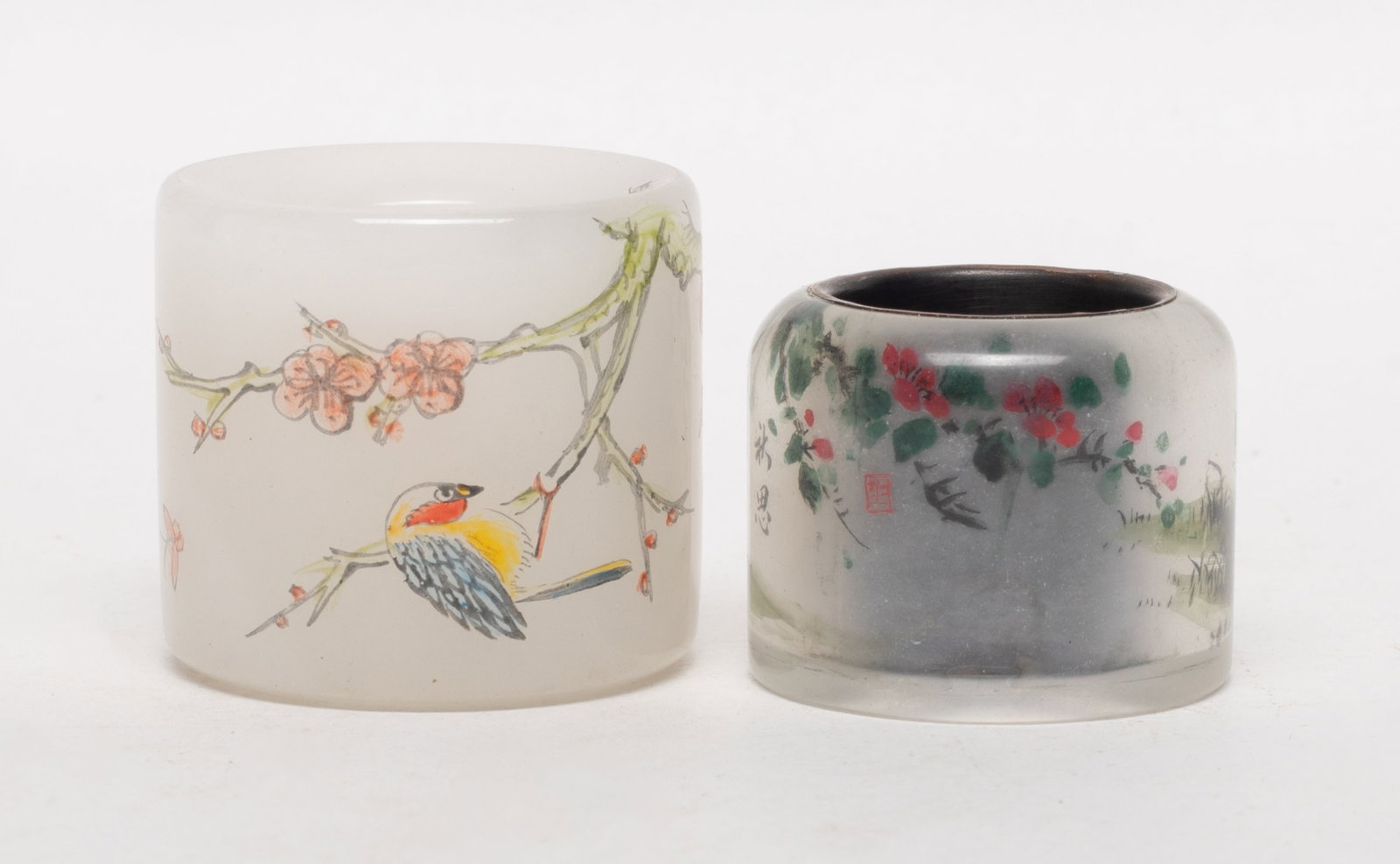 Two Chinese Peiking Glass Thumb Rings: One thumb ring painted flowers, birds and butterflies, marked four characters, the other painted a cricket and flowers. Approx. 1.55*1.4 inch (larger).