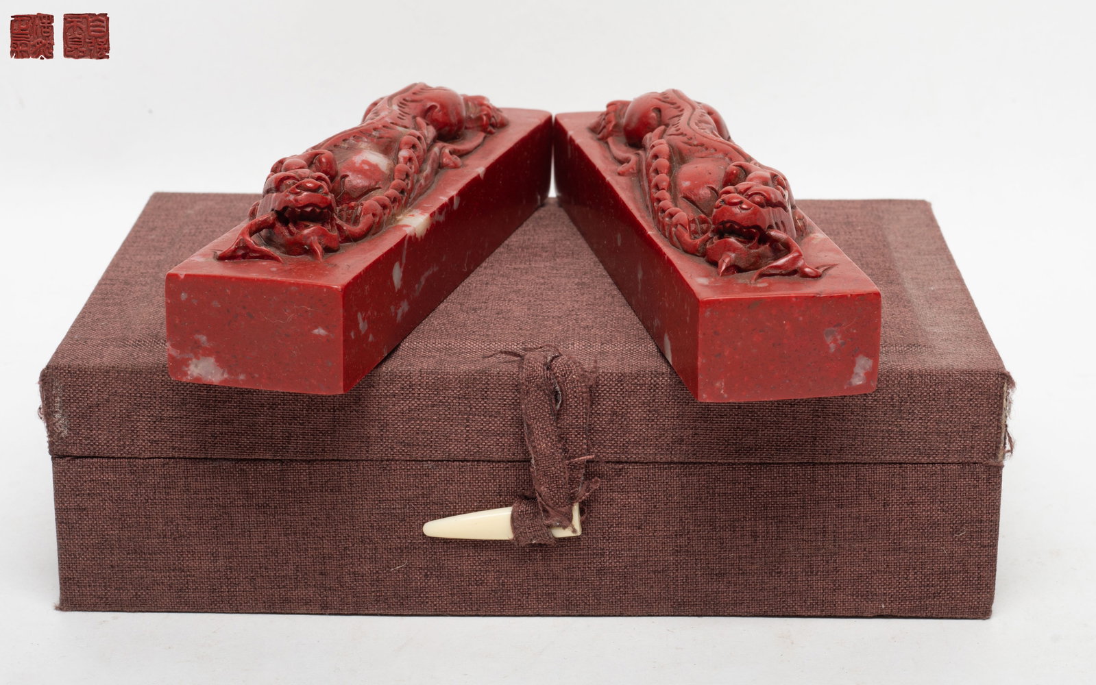 Two Chinese Stone Paper Weights: Two Chinese stone paper weights, each carved in relief with a beast grasping a string of coins in mouth, with box. Approx. 6.7*1.6*1.6 inch (each).