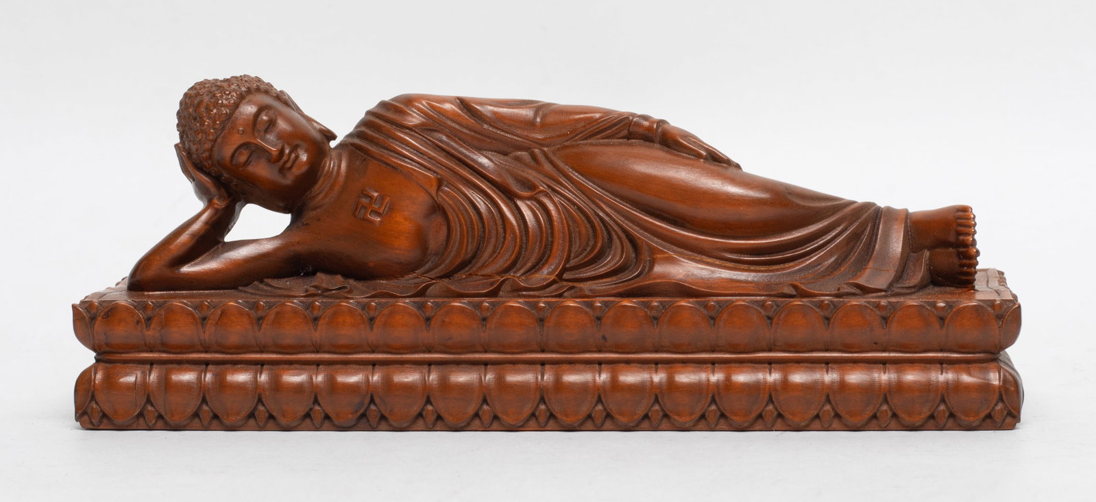 Estate Chinese Wood Sculpture of Buddha: Chinese wood carved lying Buddha sculpture, the chest with a swastika symbol. Approx. 5.9*2.1*1.8 inch.