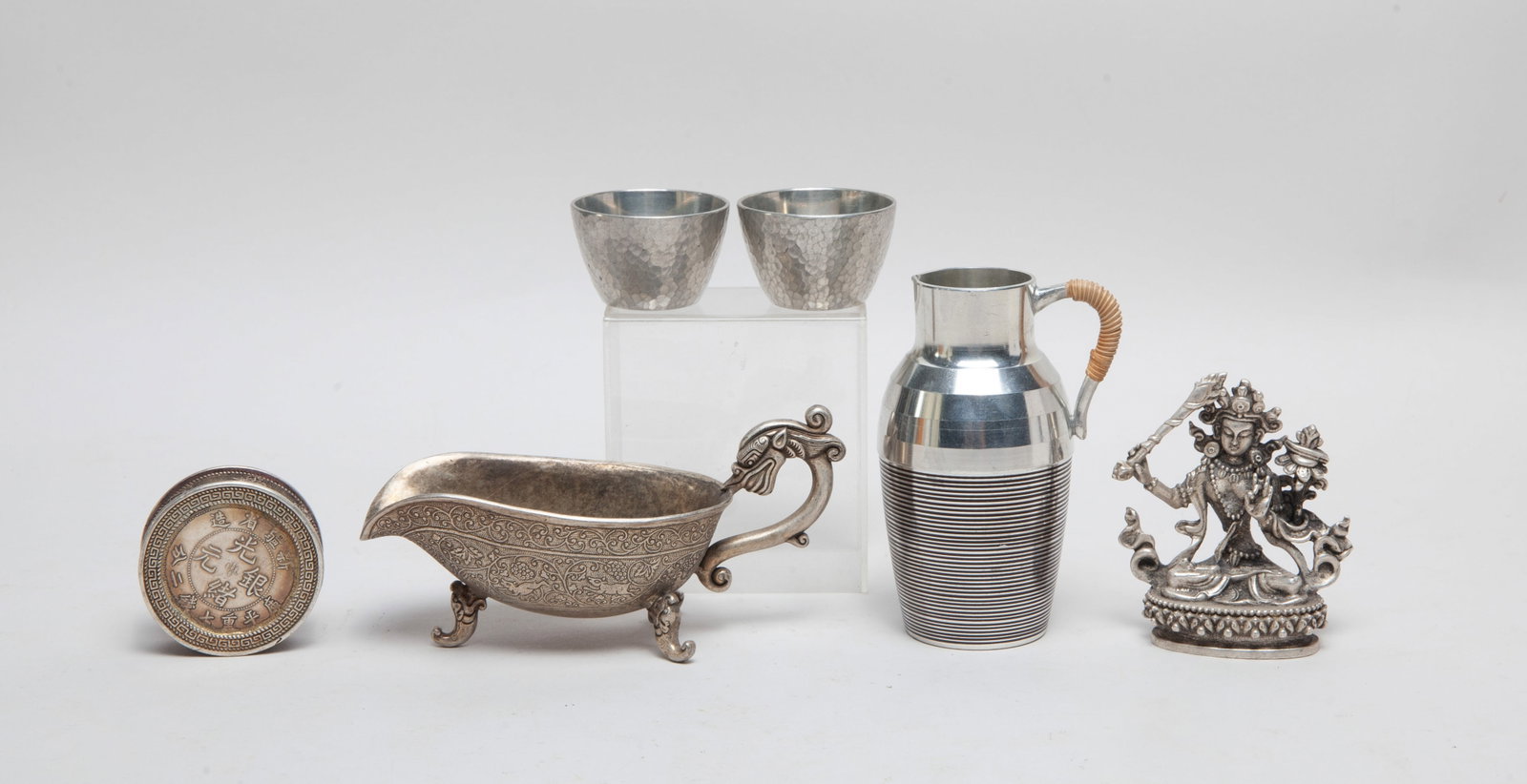 Estate Asian Metal Wares Set: Including a case, a Buddha sculpture, a pitcher, a gravy boat and two cups. Approx. 5.5*2.6*2.3 inch (largest). The Estate of the Moving & Heritage of Pasadena, CA, 2024.
