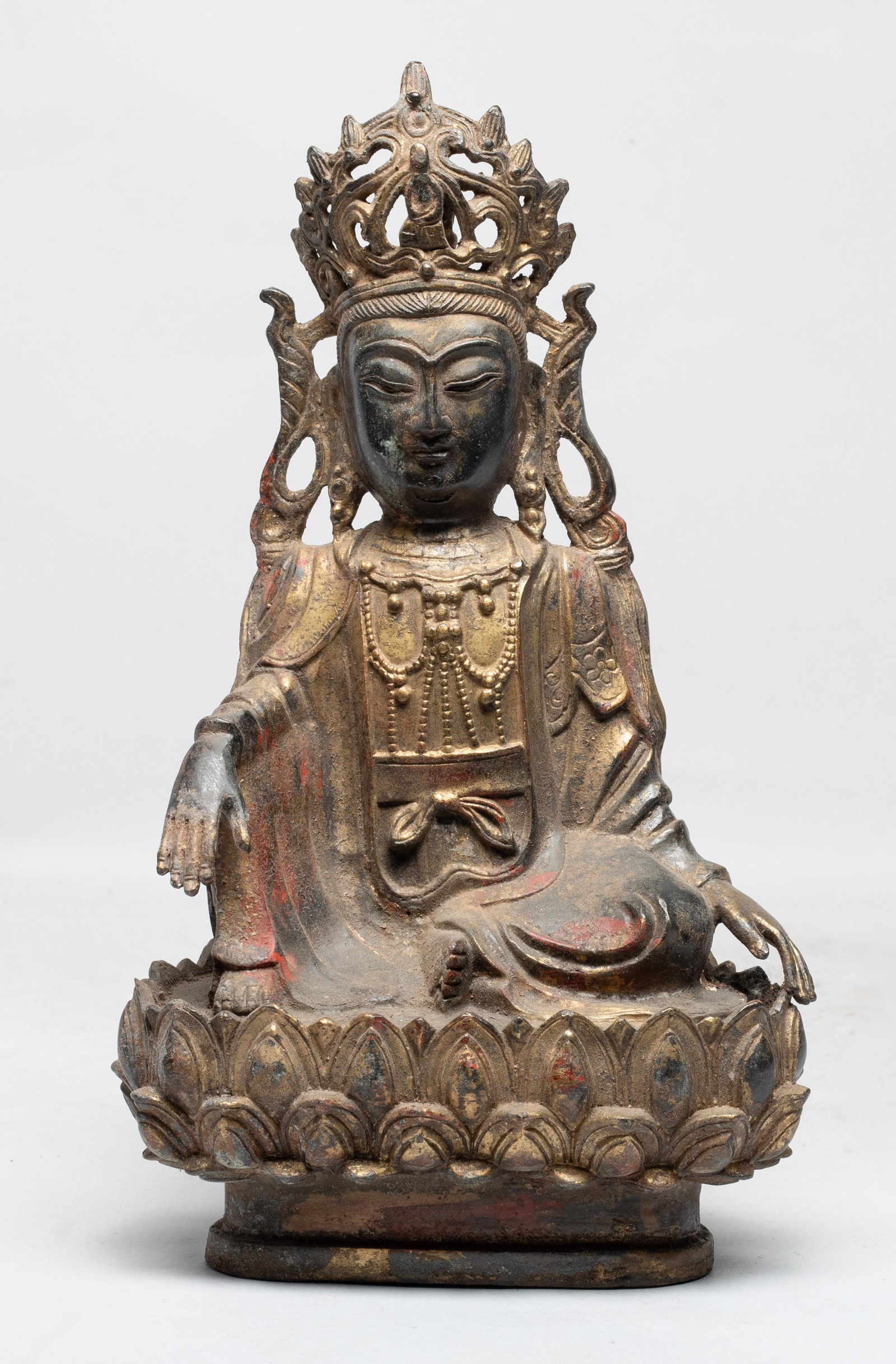 Chinese Painted Bronze Sculpture of Buddha: The Buddha cast seated on a lotus throne, the hands resting over knees, wearing a loose fitting robe, decorated with a diadema and a beaded necklace. Approx. 10.8*6.2*4.2 inch. The Estate of the E Los