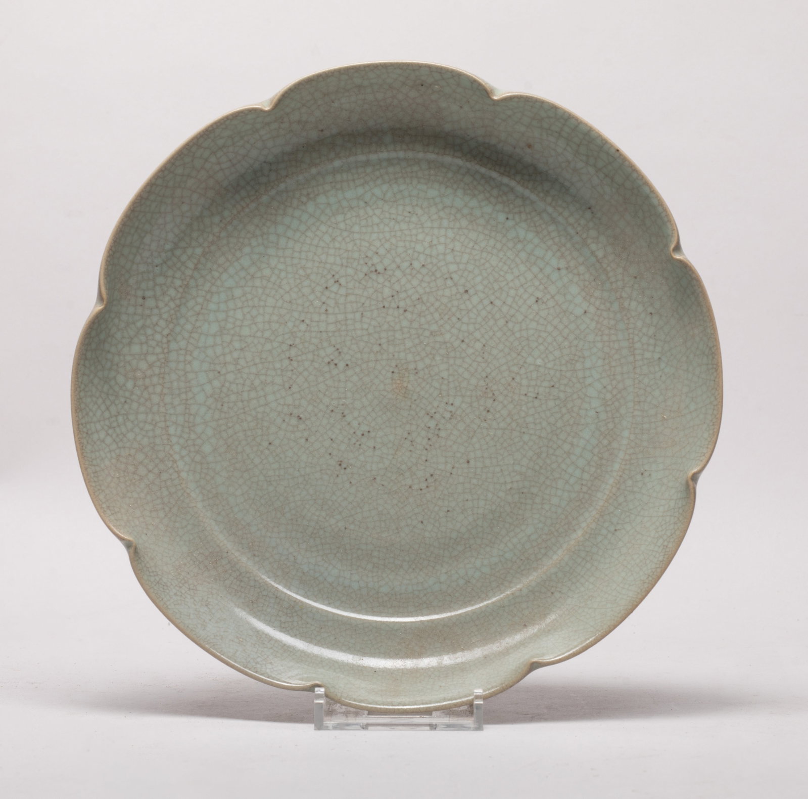 Chinese Ge Type Porcelain Lotus Plate: Of floral shape, overall covered with soft celadon glaze suffused with a matrix of crackles. Approx. 7.7 inch D.
