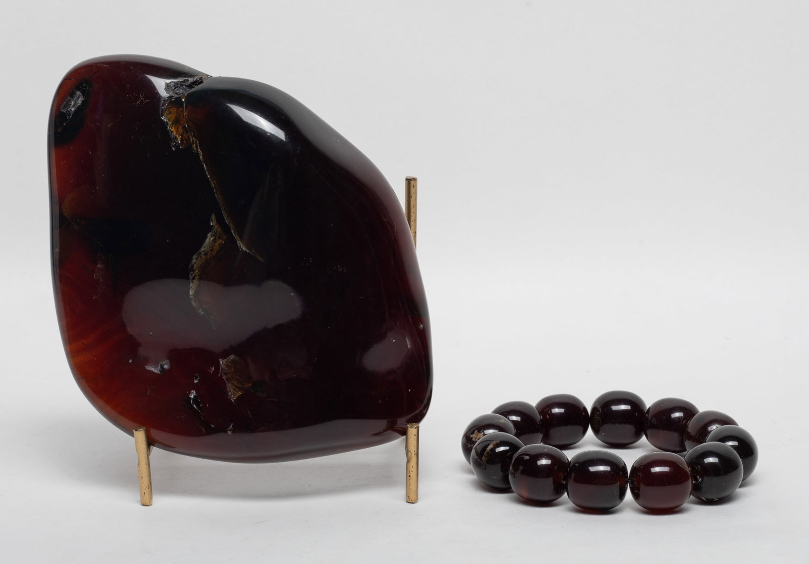 South Asian Amber Sculpture, Prayer Beads: South Asian amber sculpture, with stand, and a string of prayer beads. Approx. 368 gram (total amber weight). 6.1*4.6*1.55 inch (sculpture size).