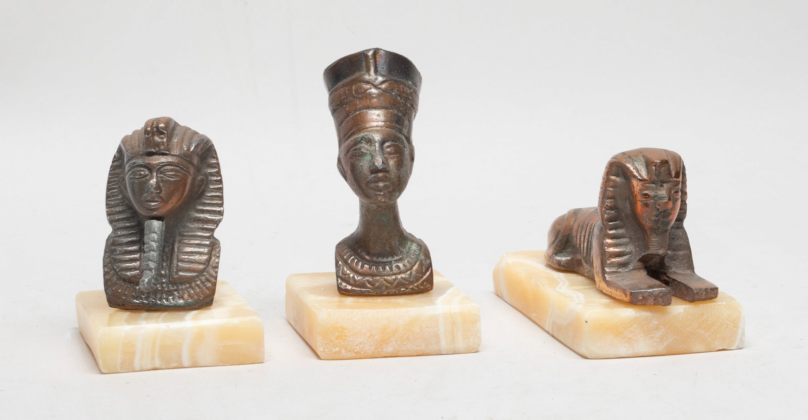 Egyptian Bronze Sculptures on Marble Base: Three bronze sculptures of Egyptian Sphinx, king or queen form on marble bases. Approx. 5*2.8*2.4 inch (largest).