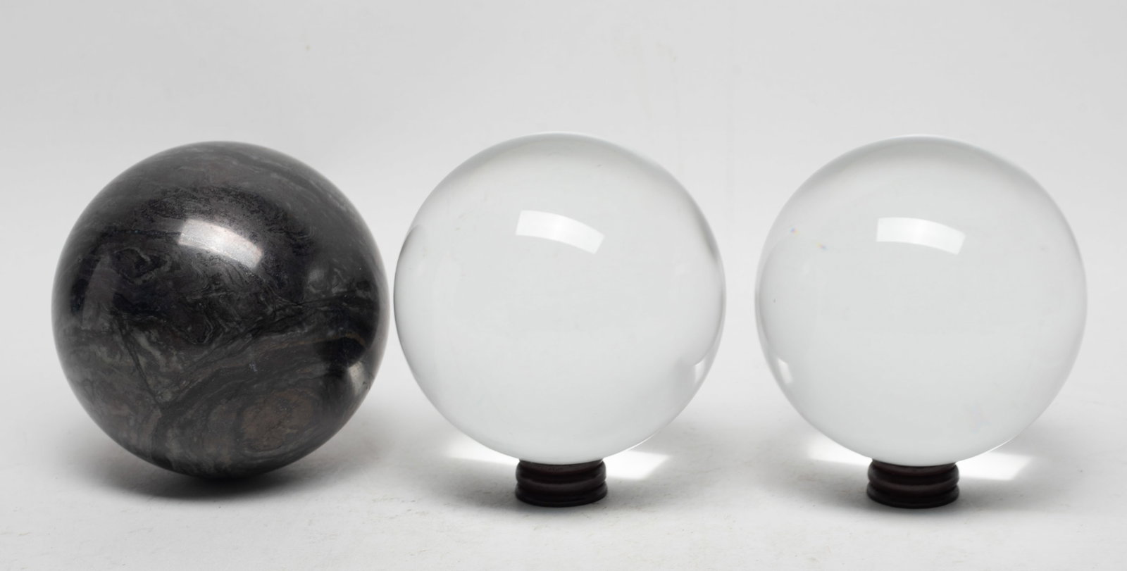 Vtg. Crystal Glass, Meteorite Like Balls: Including two crystal glass balls and a meteorite-like ball, with two stands. Approx. 4 inch D (largest ball).