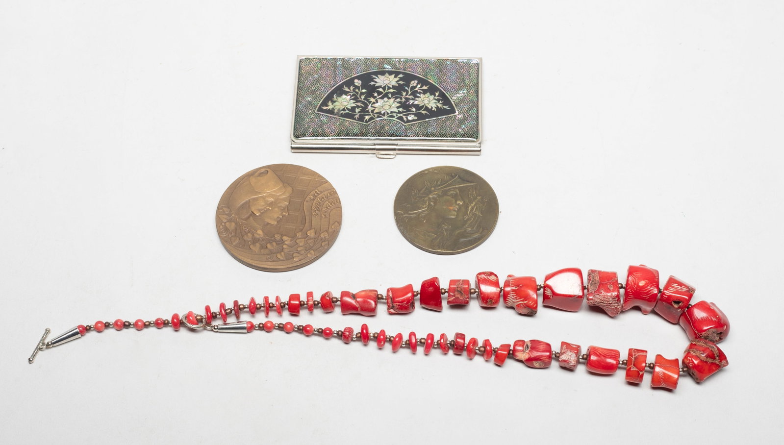 Vtg. Badges, Inlaid MOP Case, S American Necklace: Including a necklace, a card case inlaid mother-of-pearl, and two metal badges. Approx. 20 inch L (necklace size).