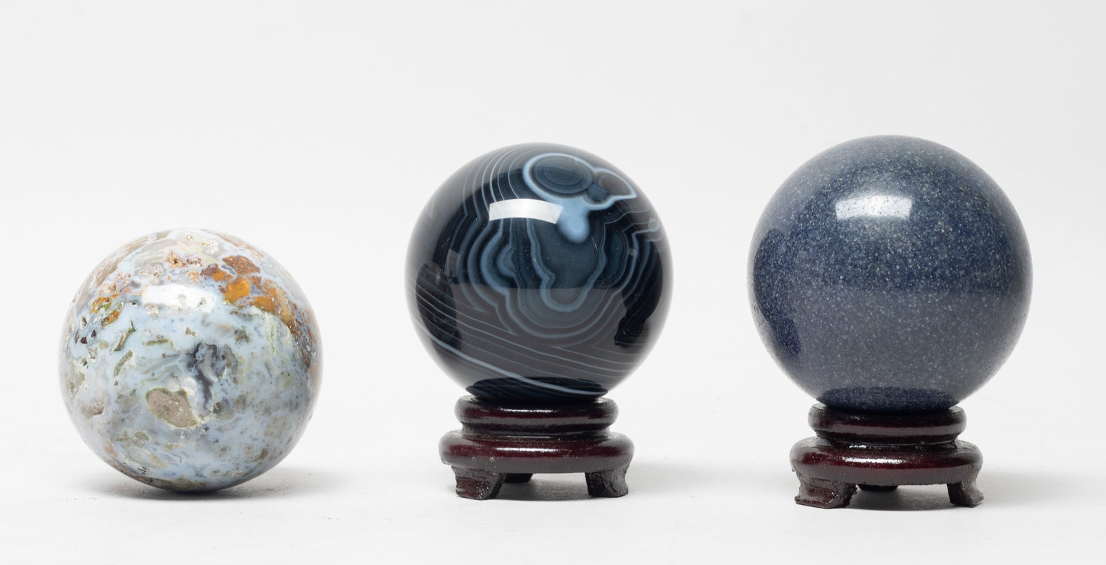 Chinese Banded Agate, Medicine Agate, Lapis Balls: Three Chinese ball sculptures carved of banded agate, medicine agate or lapis, with two stands. Approx. 2.4 inch D (largest).