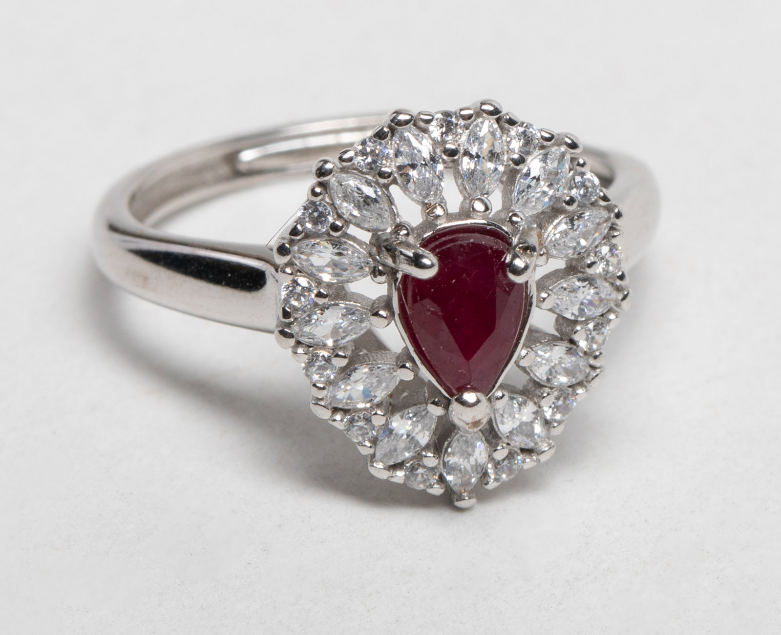 Vintage Ruby w. Simulated Diamond Ring: Vintage ring inlaid with ruby cut ring face and simulated diamond, marked S925. US size: 7. Approx. 2.8 gram. Unsure diamond is natural or lab
