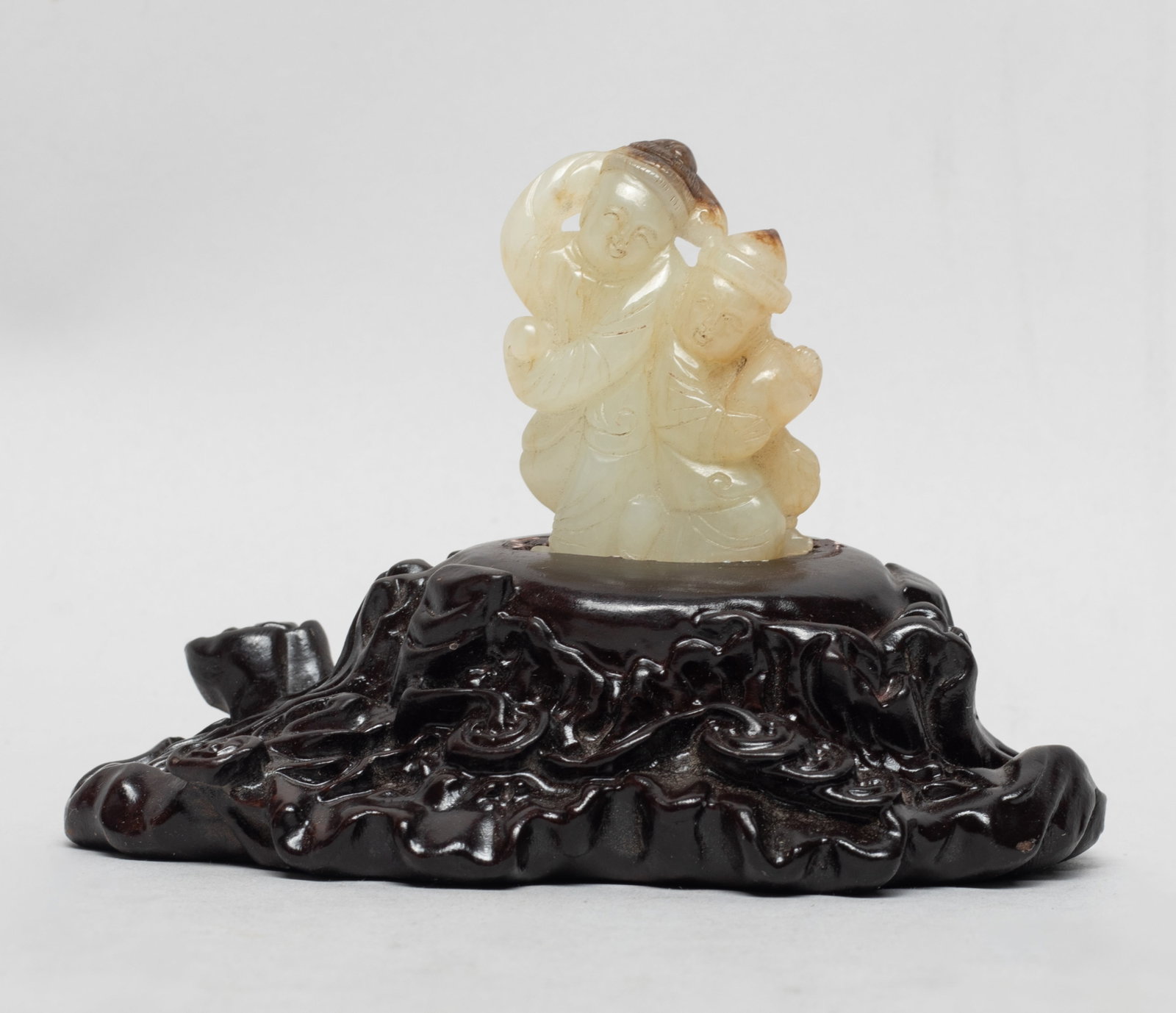 Chinese Tang Type Russet Jade Figure: Chinese russet jade carved as two dancing boys, affixed to a wood base. Approx. 4.6*3.2*2.8 inch (w/ stand).