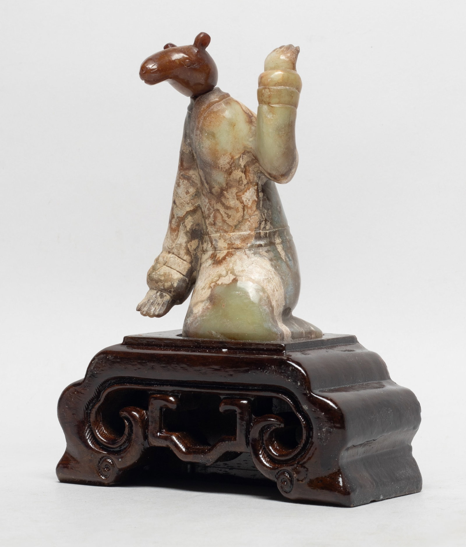 Rare Chinese Five Dynasty Form Jade Sculpture: Chinese jade carved kneeling figure with beast head, affixed to a wood base. Approx. 4.6*2.3*6.2 inch (w/ stand).