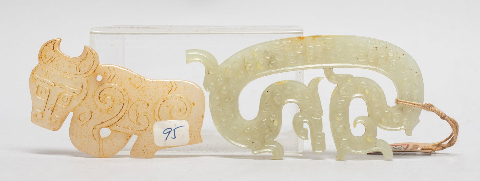 Two Chinese Export Jade Pendants: Two Chinese jade pendants, one carved of buffalo form and the other of C-shaped dragon form. Approx. 3.4*1.8 inch (larger).