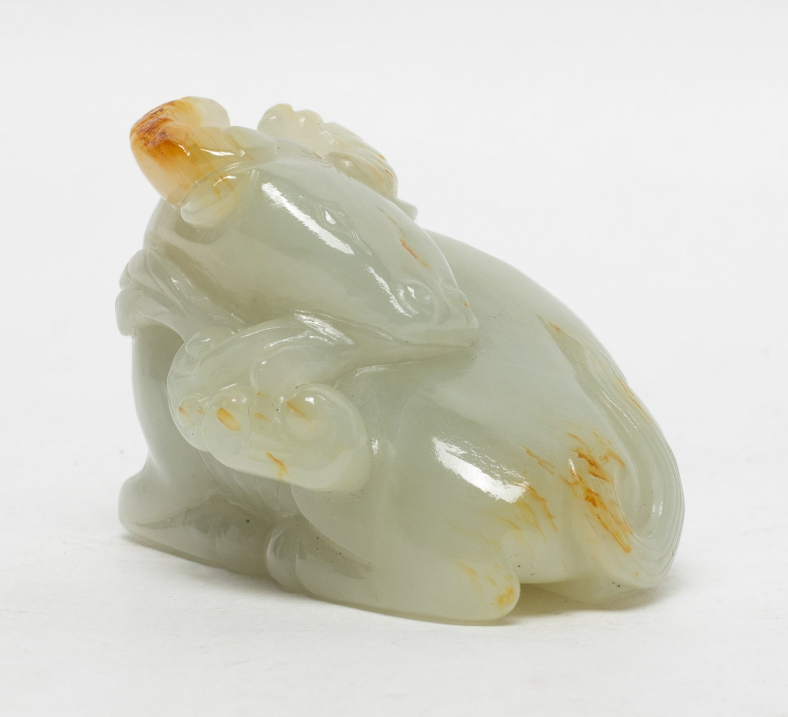 Estate Chinese Russet Jade Sculpture: Chinese russet jade sculpture, carved as a recumbent buffalo grasping lingzhi in mouth. Approx. 2.3*1.9*1.7 inch.