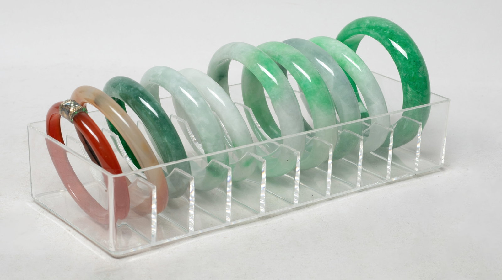 Set Chinese Export Bangle Collections: Set of ten Chinese colored bangles, with case. Approx. 2.97 inch outer diameter, 2.33 inch inner diameter (largest).