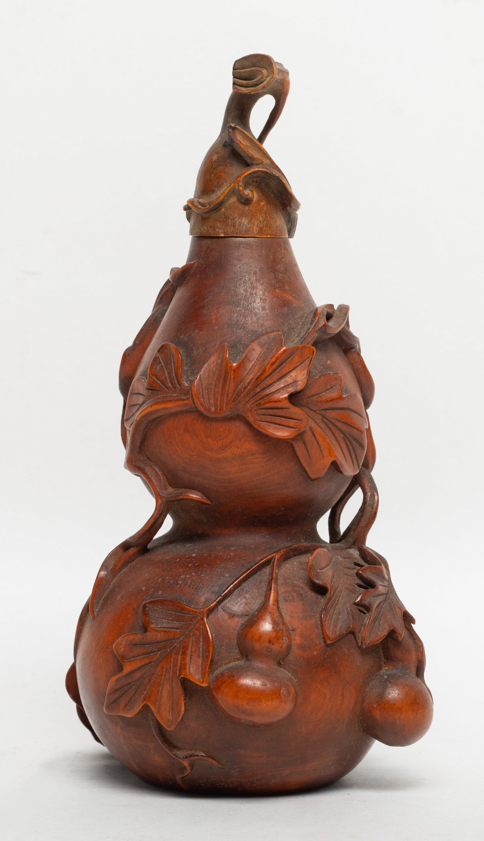 Chinese Wood Carved Gourd Covered Cabinet Vase: Chinese wood covered cabinet vase of gourd form, carved in relief with leafy gourd vines. Approx. 6*3.4*3.1 inch.