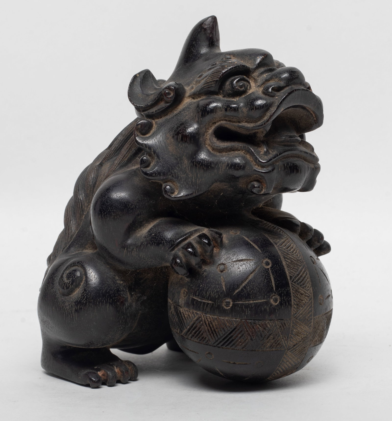 Estate Chinese Zitan Wood Foo Dog Sculpture: Chinese Zitan wood carved sculpture as a foo dog holding a ball. Approx. 4.6*3.8*3.6 inch.