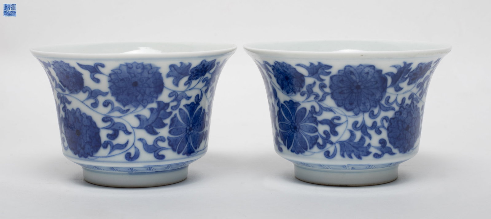 Two Chinese Blue & White Porcelain Tea Cups: Two Chinese blue and white porcelain tea cups painted lotus scrolls, six-character mark on each bottom. Approx. 3.6*2.3 inch (each).