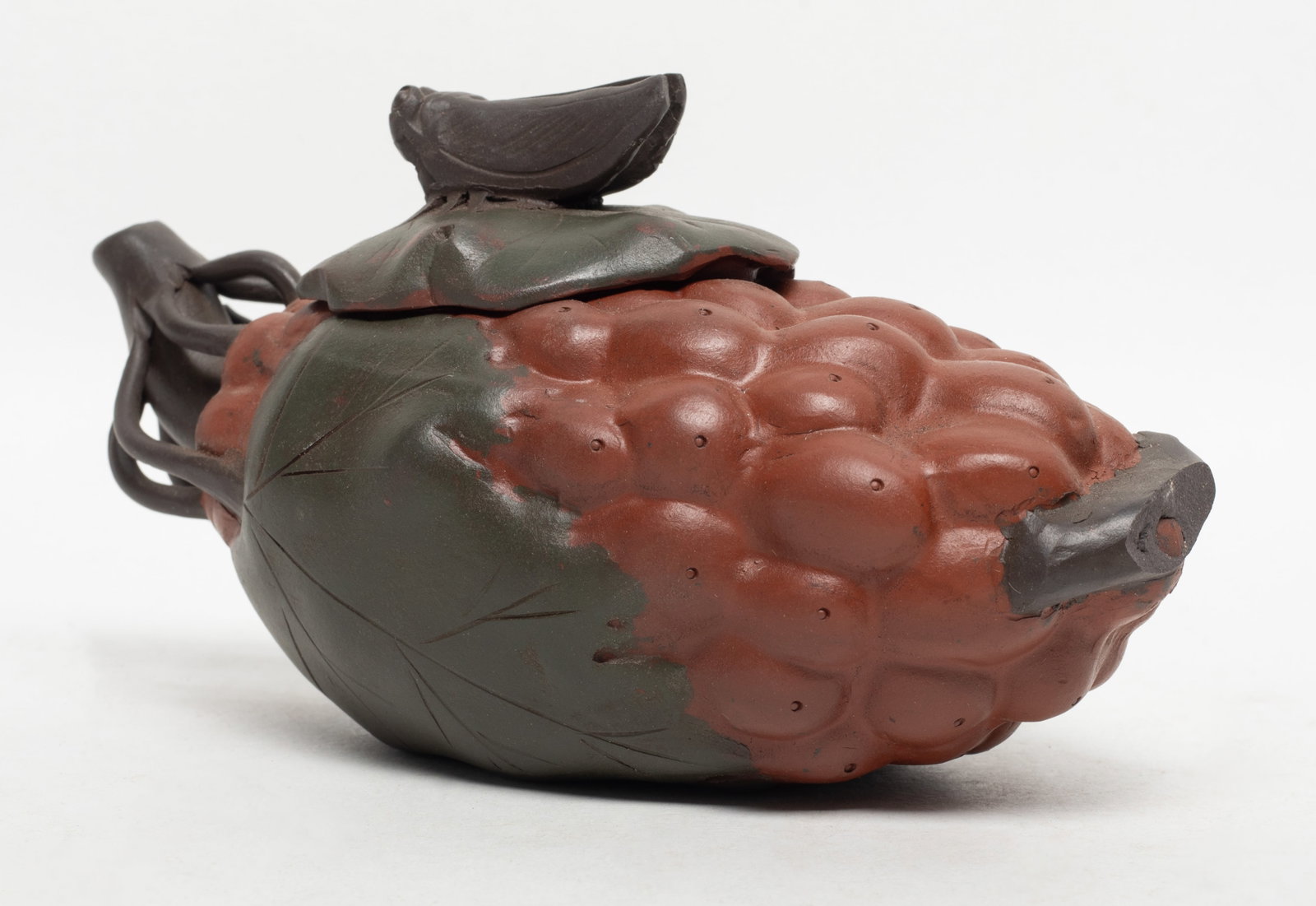 Chinese Fruit Form Zisha Tea Pot: Chinese grape form zisha tea pot, the cover with a cicada knob, incised mark to bottom. Approx. 6.5*3.4*3.1 inch.