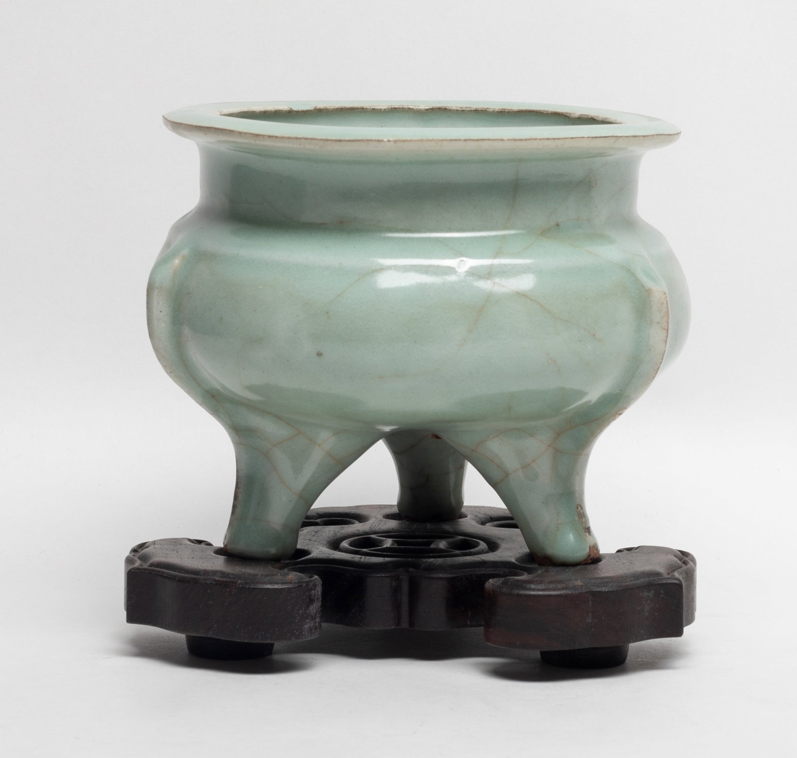 Chinese Longquan Porcelain Censer w/ Wood Base: Chinese triple feet celadon glazed Longquan porcelain censer, with wood stand. Approx. 6*4.9 inch (w/o stand).