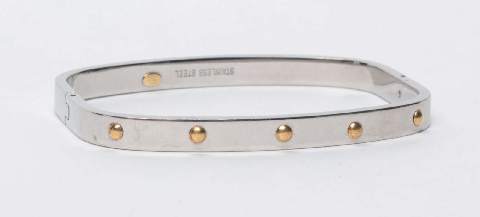 Vtg. Italy 18K Gold Stainless Steel Bangle: Vintage Italy designed bangle, marked STAINLESS STEEL, 18KT ITALY MILOR. Approx. 22 gram, 2.5 inch width.