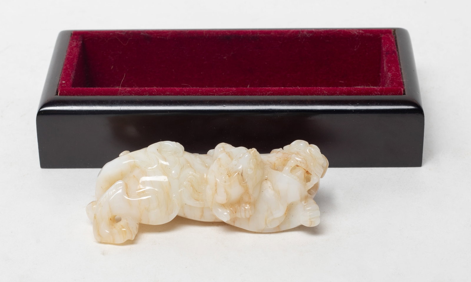 Chinese Chicken Bone Color Jade Beast Pendant: Chinese chicken bone color jade pendant with russet streaks, carved of beast form, with a lidless box. Approx. 2.97*1.2*1.1 inch (jade size).
