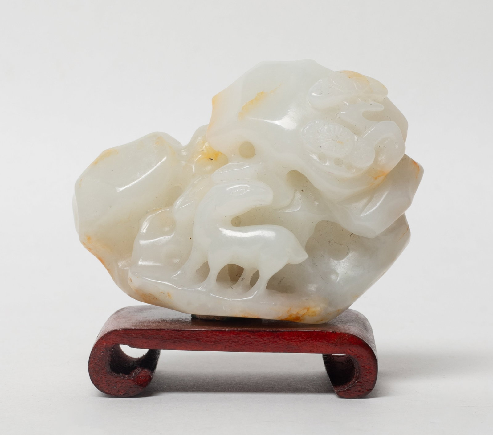 Estate Chinese Russet White Jade Sculpture: Chinese white and russet jade sculpture carved with deer, lingzhi, pine branch and rocks, with stand. Approx. 2.55*1.85*1.17 inch (w/o stand). The Estate of the K. T. Lam. HK. 1998.