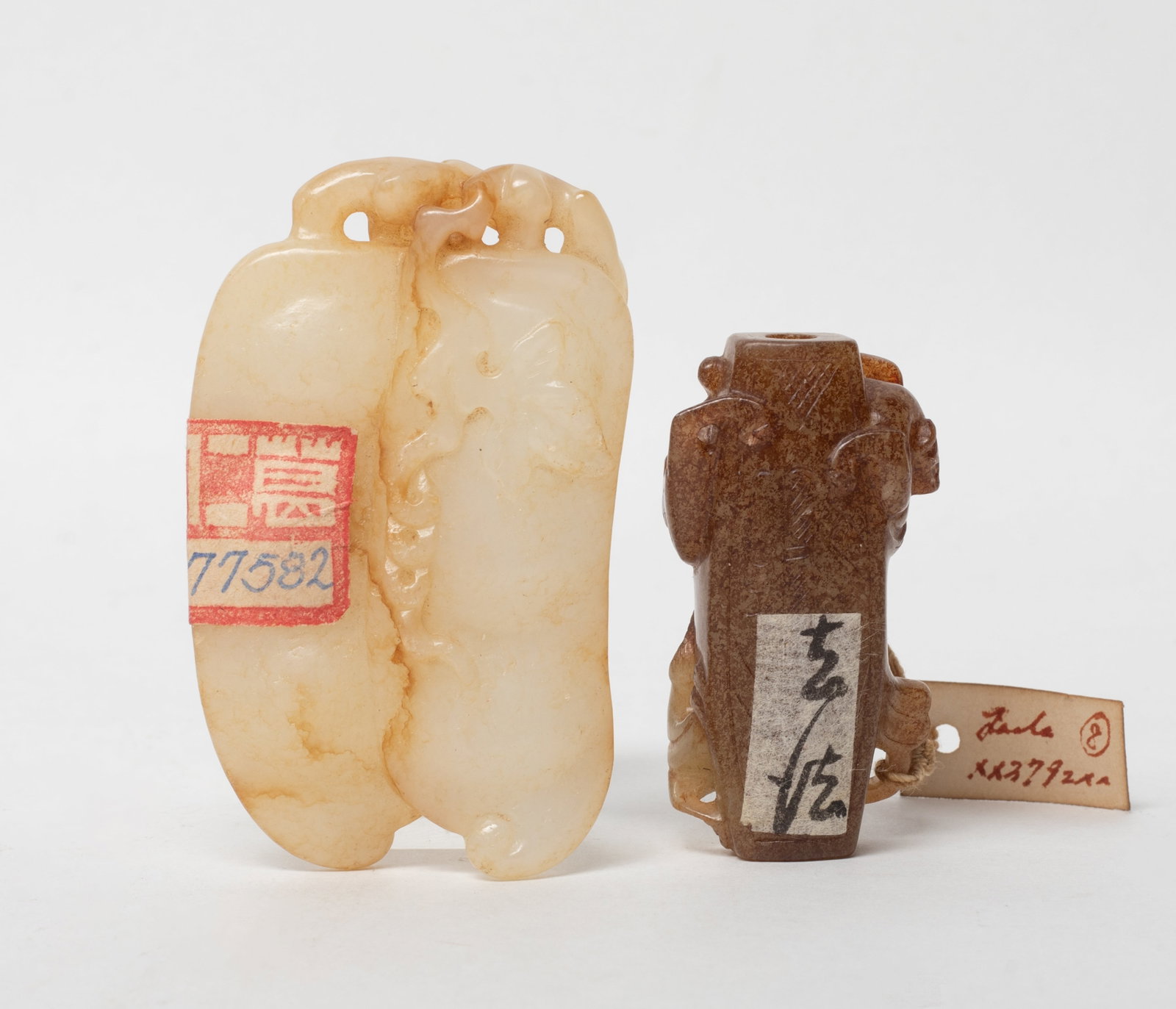 Two Chinese Export Jade Carved Pendants: Two Chinese jade pendants, one carved of peapod form, the other carved with beasts. Approx. 2.8*1.7 inch (larger).