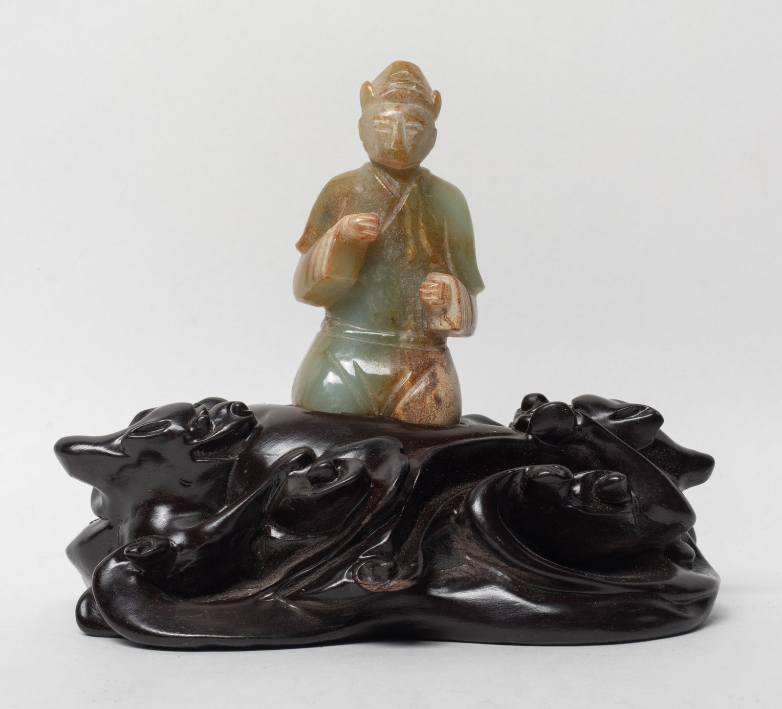 Chinese Russet Jade Figure w/ Large Wood Base: Chinese russet jade sculpture carved as kneeling figure, affixed to large wood base. Approx. 5.6*4.8*3.4 inch (w/ stand). The Estate of the K. T. Lam. HK. 1998.