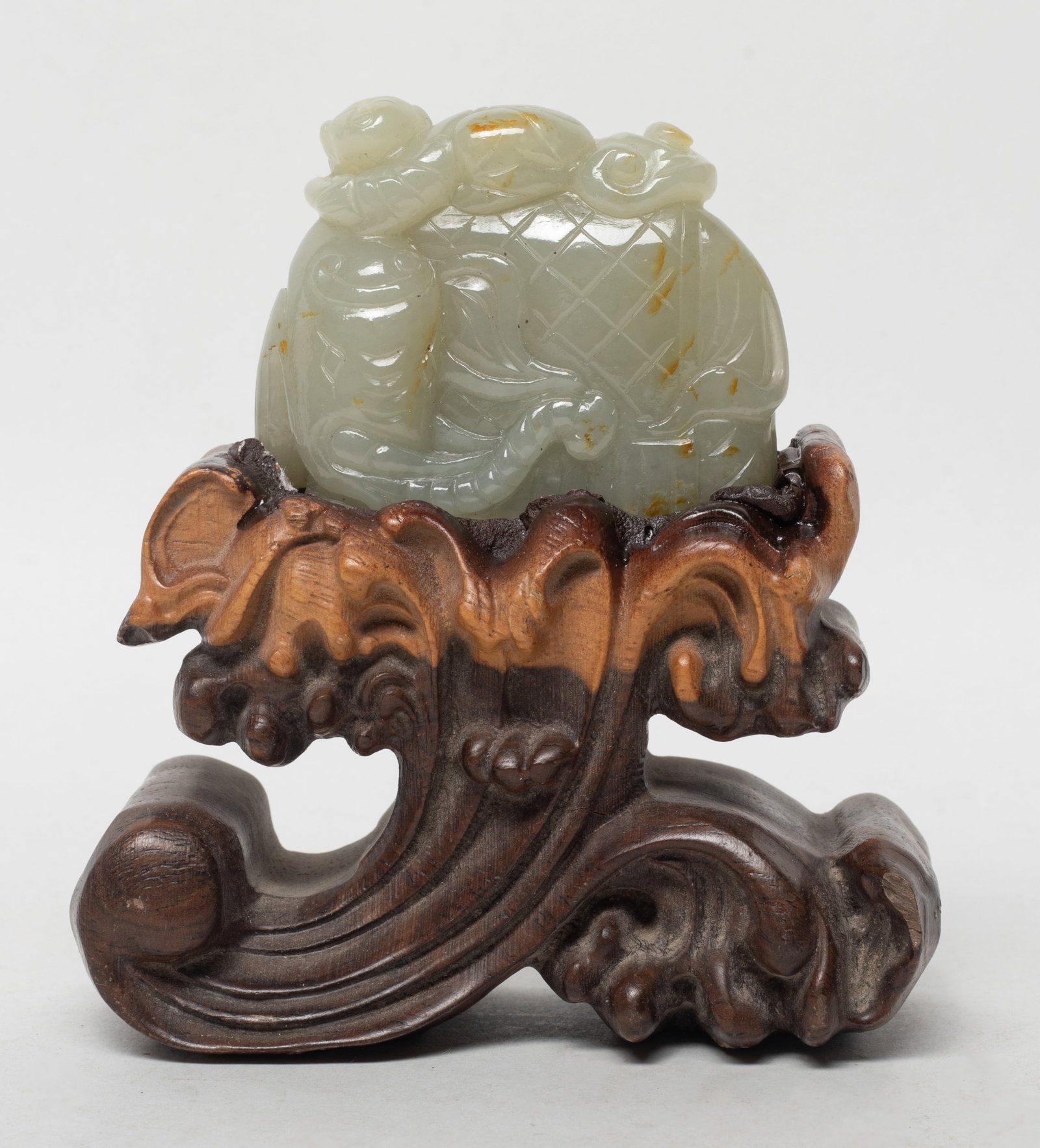 Estate Chinese Jade Carved Sculpture w/ Base: Chinese jade sculpture carved as a boy lying on an elephant, the hands holding lingzhi branch, with wood stand. Approx. 4.2*3.95*1.7 inch (w/ stand). The Estate of the K. T. Lam. HK. 1998.