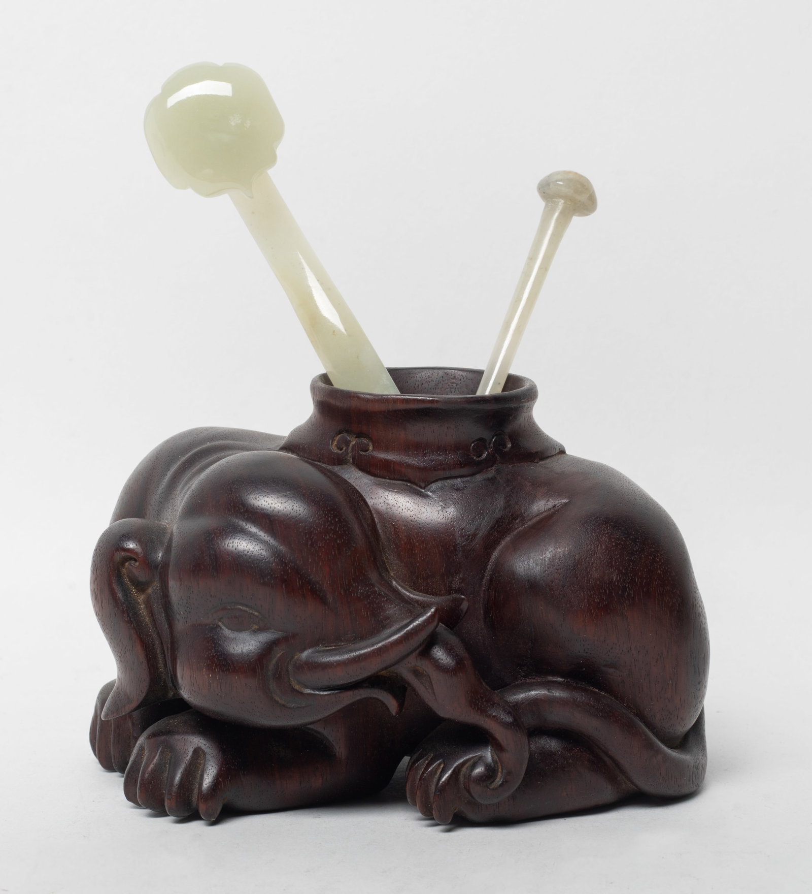 Rare Chinese Tan Wood Sculpture w/ Jade Pins: Chinese tan wood sculpture carved of recumbent elephant form, with two jade pins. Approx. 4.9*3.4*3.1 inch (wood size). The Estate of the K. T. Lam. HK. 1998.
