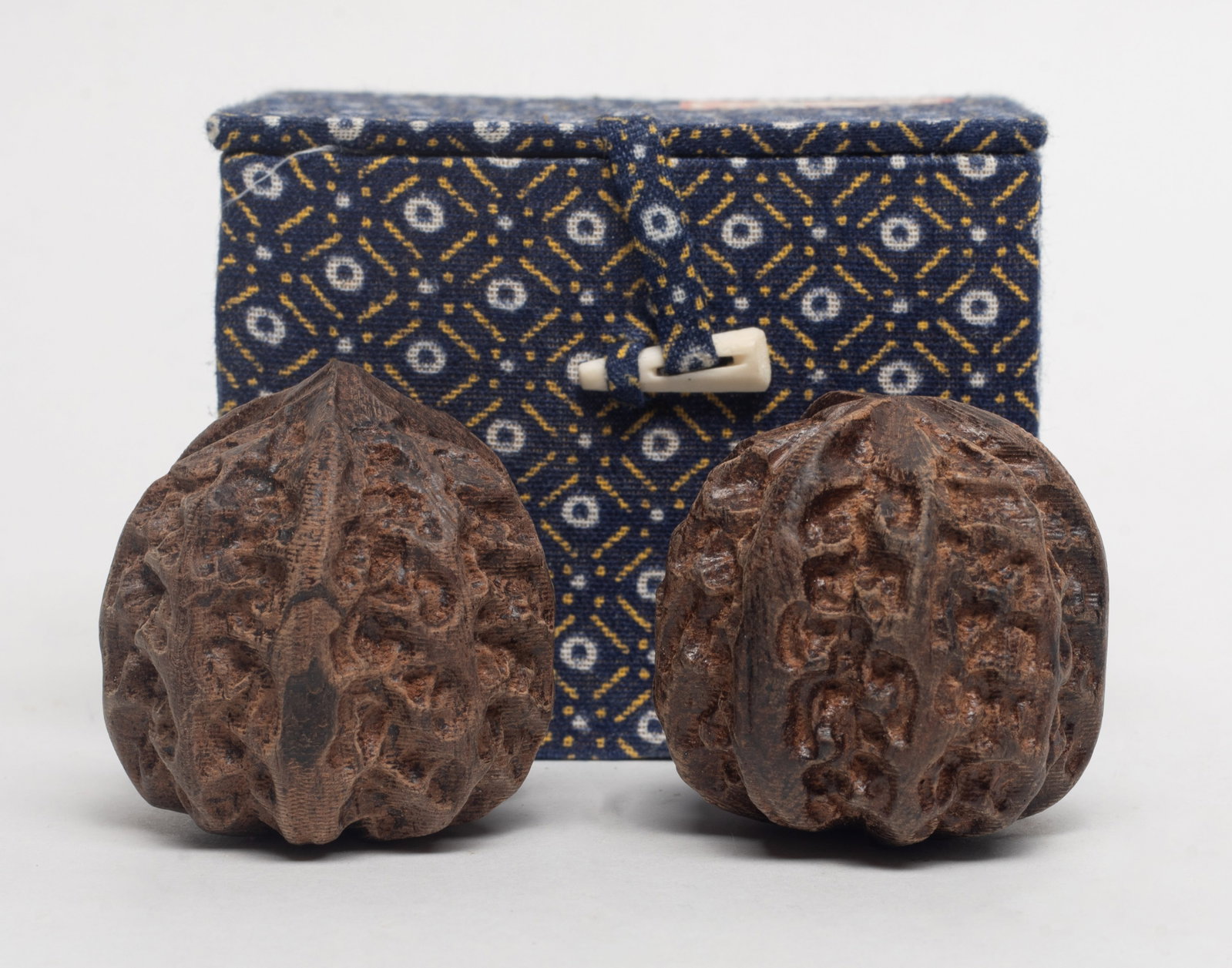 Two Chinese Agarwood Carved Toy Nuts: Two Chinese agarwood carved toy nuts, with box. Approx. 90 gram, 1.64*1.68 inch (larger).