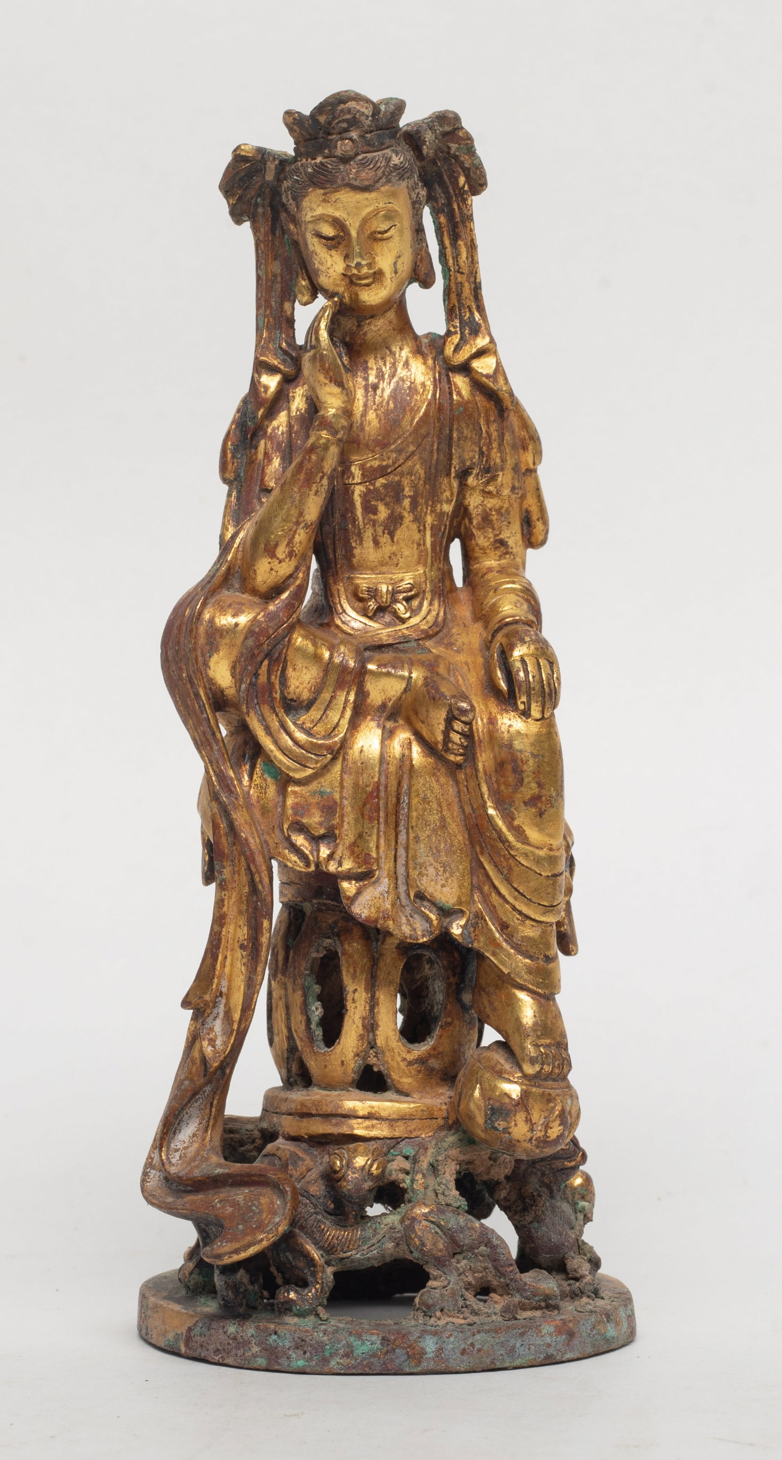 Chinese Early Style Gold on Bronze Buddha: Chinese gold on bronze Buddha sculpture, cast seated on tall pedestal, the face with serene expression. Approx. 5.7*2.3*2.2 inch.