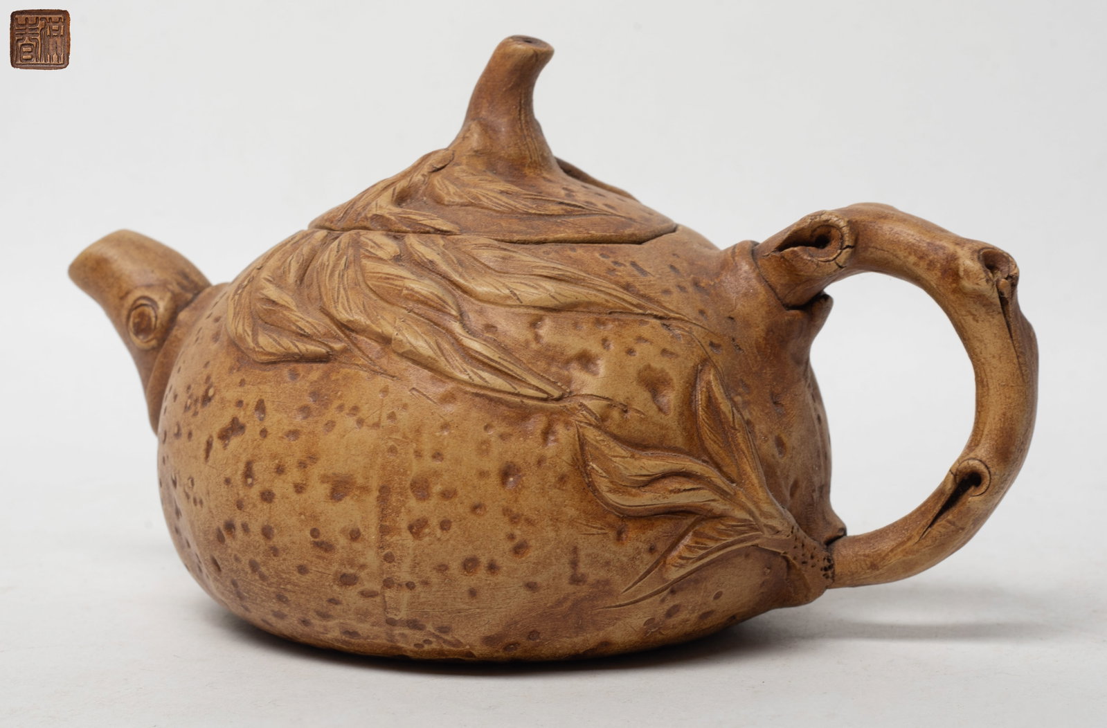 Estate Chinese Yixing Zisha Tea Pot: Chinese Yixing zisha tea pot carved with branch and leaves, incised seal mark on the bottom. Approx. 7.1*4*4.5 inch.
