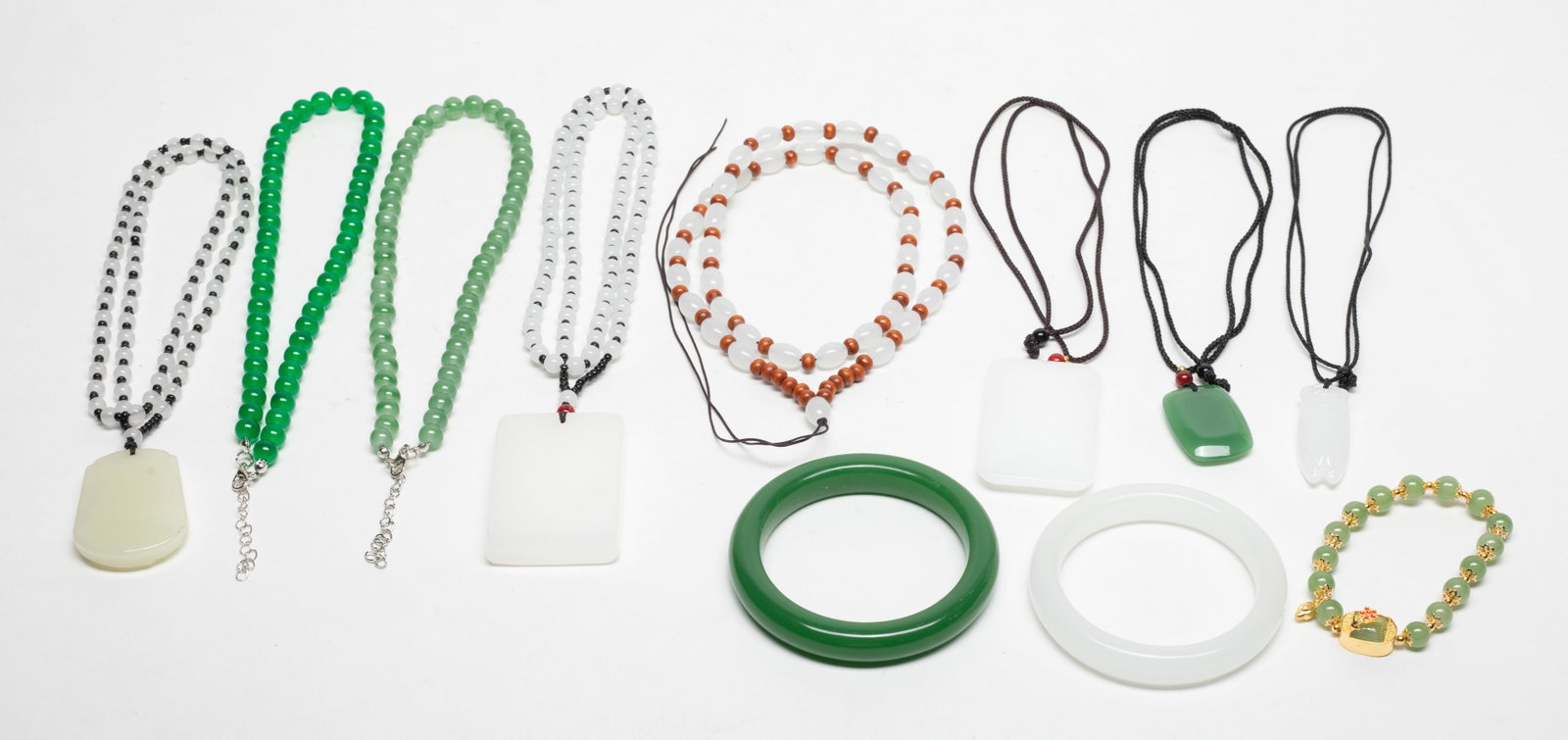 Large Set Chinese Export Glass/Colored Jewelry: Including bangles, bead necklaces, carved pendants, and a bead bracelet. Size varies.