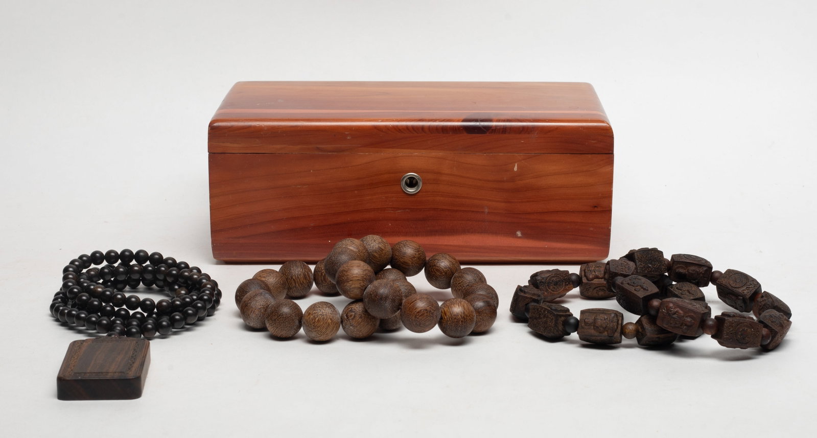 Collectible Chinese/ S Asian Wood Prayer Beads: Four strings of Chinese / South Asian wood carved prayer beads and a long bead necklace with a plaque, slightly fragrant, with box. Approx. 215 gram (total wood weight), 34 inch L (necklace size).