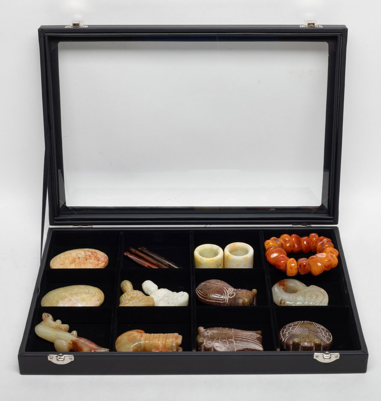 Set Chinese Export Stone Carvings: Collection of Chinese stone carvings, thumb rings, and a bracelet, with case. Size varies.