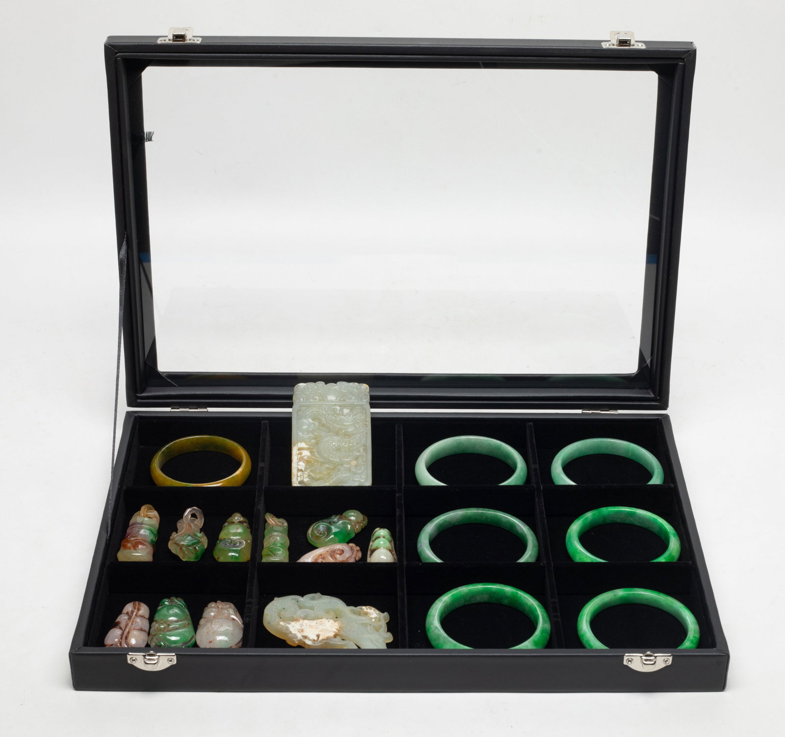 Set Chinese Export Colored Stone Carvings: Large set of Chinese colored stone carved bangles and pendants, with case. Approx. 2.83 inch outer diameter, 2.3 inch inner diameter (largest bangle).